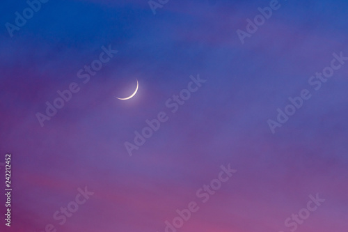 Gibbous waning moon in colorful dawning sky