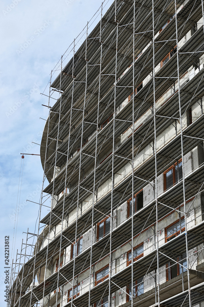 new building under construction, scaffolding and concrete new building under construction, scaffolding and concrete