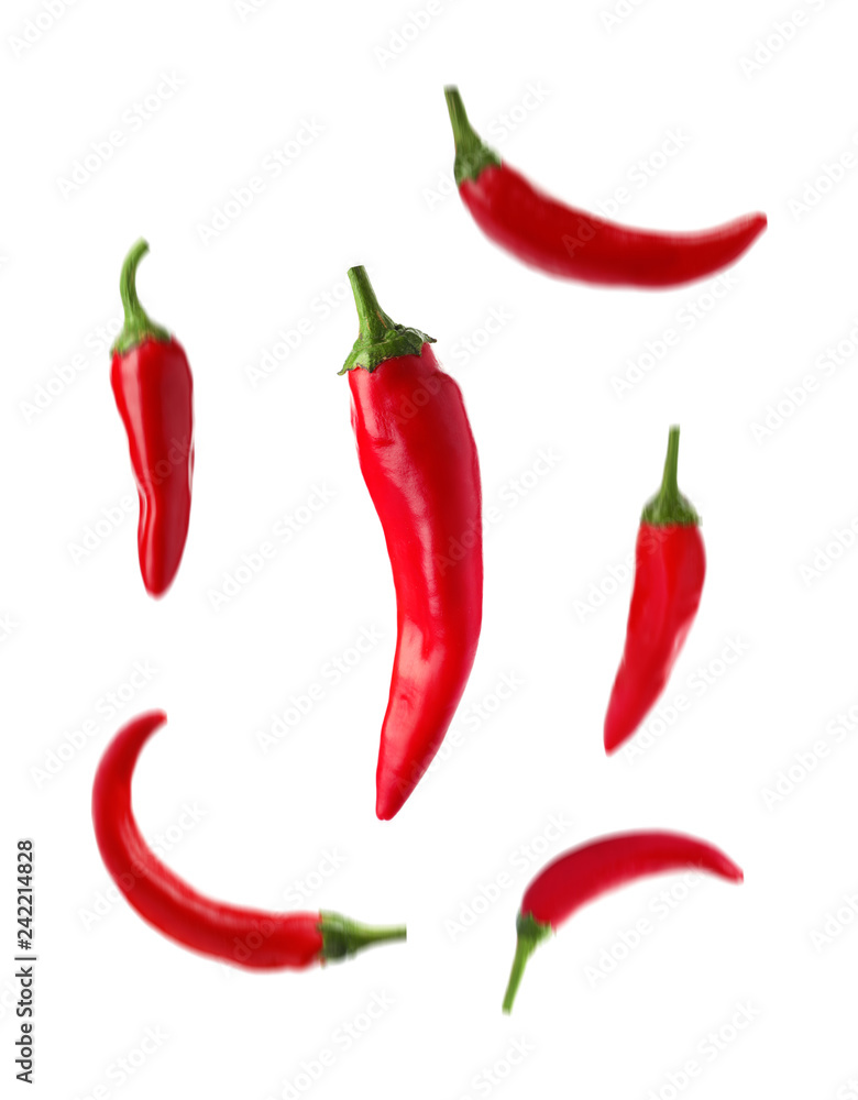 Set with fresh red chili peppers falling against white background Set with fresh red chili peppers falling against white background