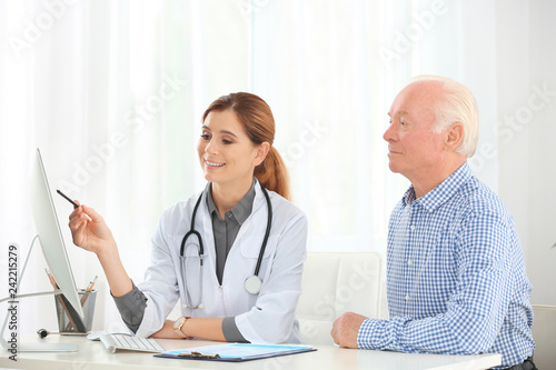 Doctor working with elderly patient in hospital