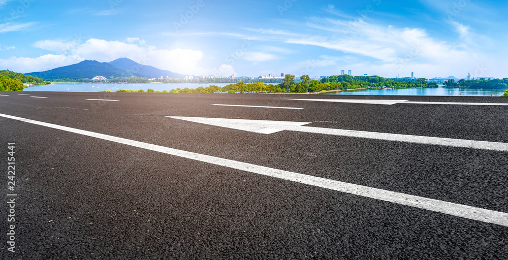 Obraz premium Empty asphalt road square and natural landscape under the blue sky