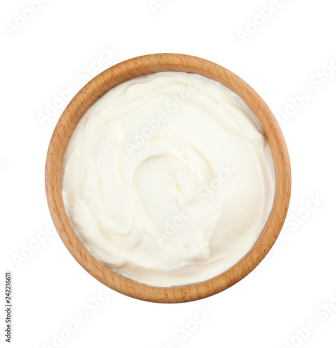 Bowl with sour cream on white background, top view