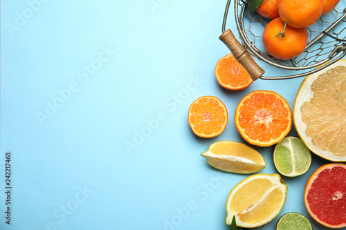 Different citrus fruits on color background, top view. Space for text