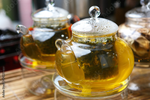 Freshly brewed tea in a glass teapot close-up