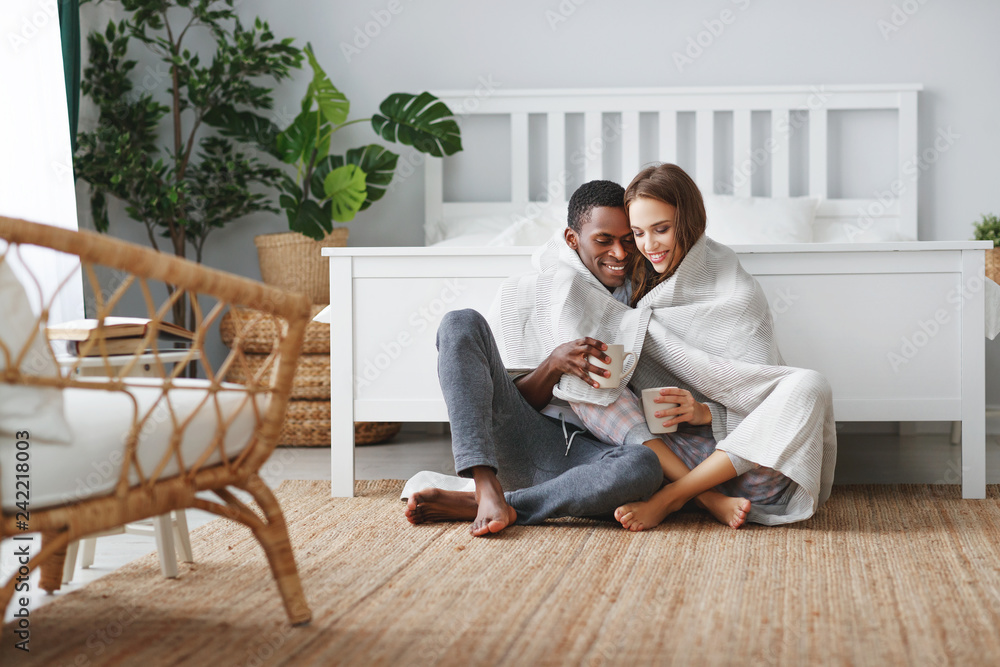happy loving couple drinking cocoa on winter morning in bed. happy loving couple drinking cocoa on winter morning in bed.