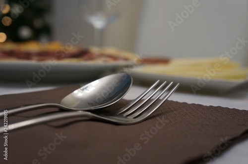 Silver cutlery for dinner with plates and napkins photo