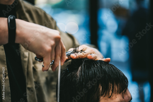 Men's haircut in barbershop. The process of haircuts is a great plan.