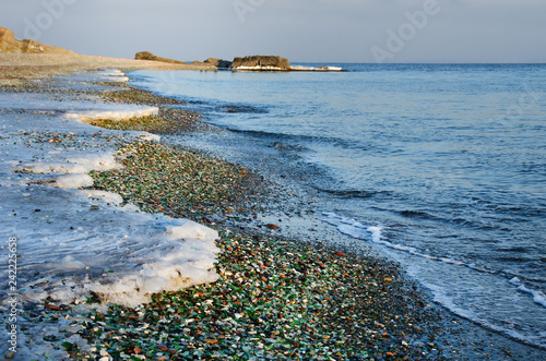 Glass beach in Steklyannaya Bay near Vladivostok. Russia, Primorsky Krai, winter in evening photo