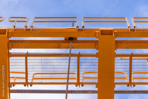 Close-up of footbridges of a launching girder against blue sky viewed from below
