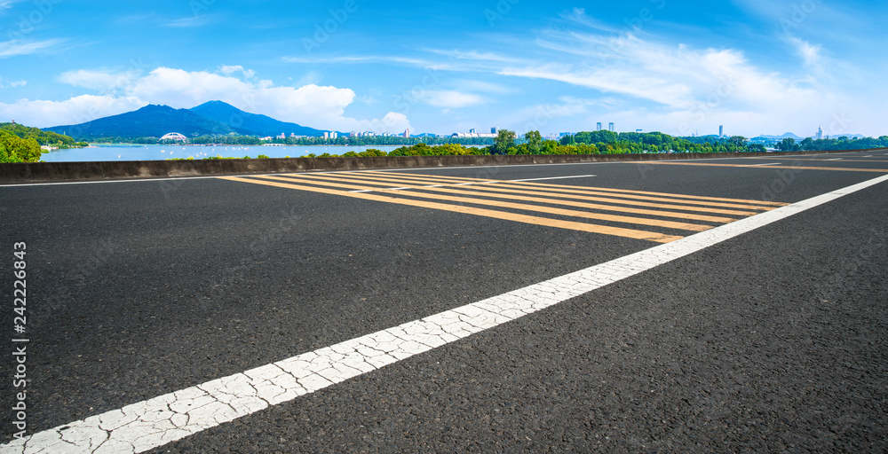 Fototapeta premium Empty asphalt road square and natural landscape under the blue sky