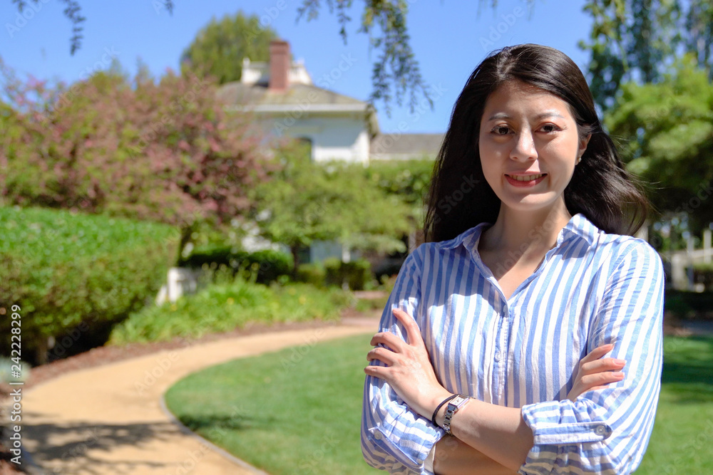 asian businesswoman standing in spring garden