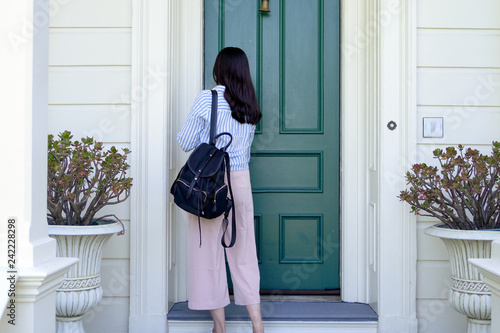 girl back to home using key opening door