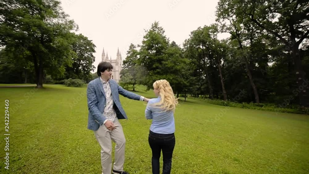 Young lovely couple dancing in a park in summer. Romantic dating or lovestory. Young lovely couple dancing in a park in summer. Romantic dating or lovestory.