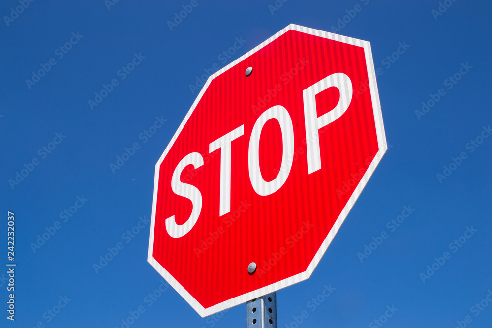 Stop sign with brilliant blue skies in the background. Stop sign with brilliant blue skies in the background.