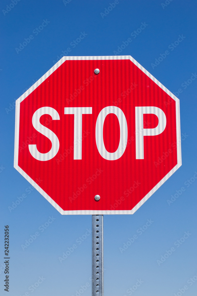 Stop sign with brilliant blue skies in the background. Stop sign with brilliant blue skies in the background.