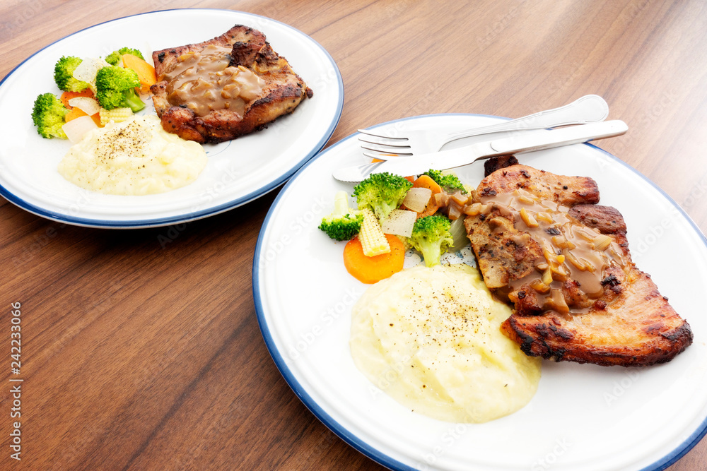 Pork steak with vegetables On the wood background Pork steak with vegetables On the wood background