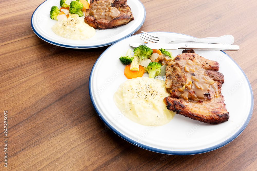Pork steak with vegetables On the wood background Pork steak with vegetables On the wood background