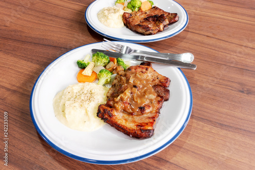 Pork steak with vegetables On the wood background