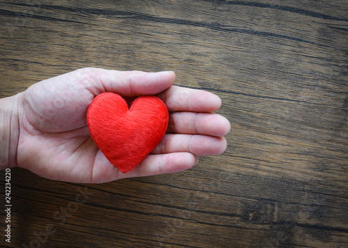 Give Love Man holding red Heart in hands for love Valentines day Donate Help Give love warmth take care concept