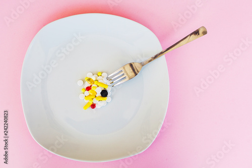 Close up of pills. Dietary supplements. Variety pills. Vitamin capsules on pink background
