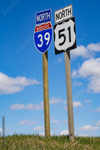 Interstate 39 & 51 road sign with brilliant blue skies and clouds in background.