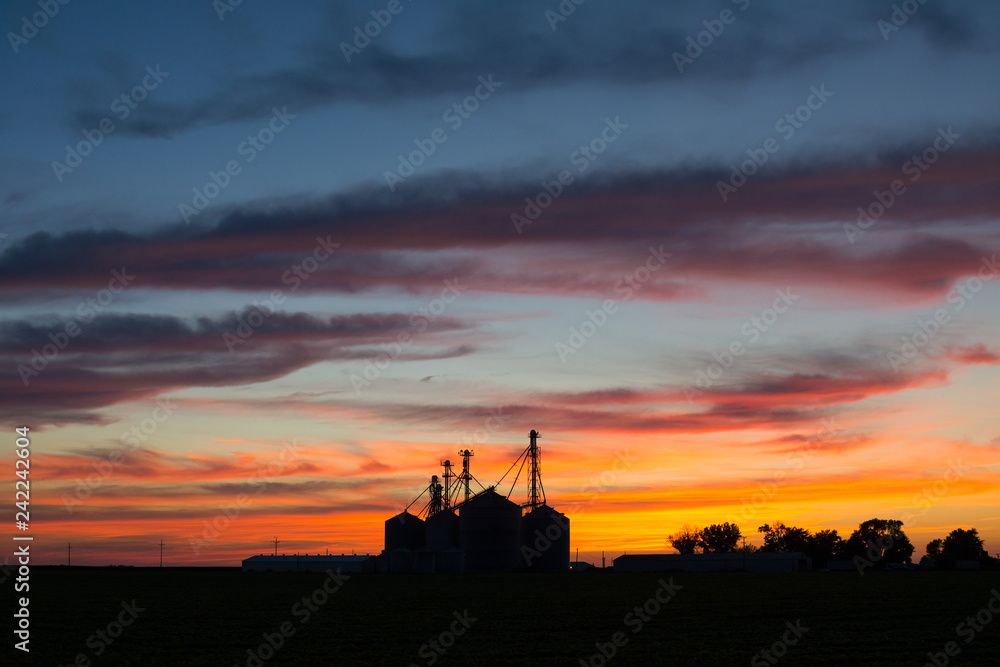 Dusk in the countryside.  Silhouette of silos with beautiful skies in background.  LaSalle County, Illinois, USA