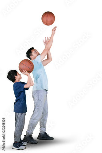 Father teaches his son to shooting a basketball