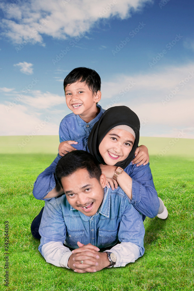 Happy family lying together in the meadow Happy family lying together in the meadow
