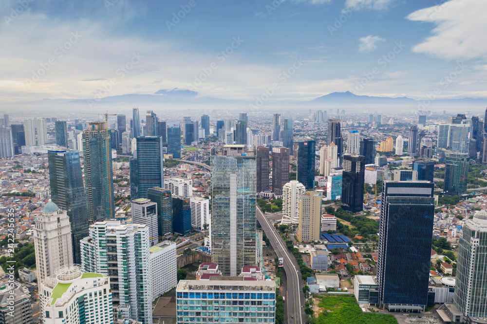 Naklejka premium Office buildings in misty mountain background