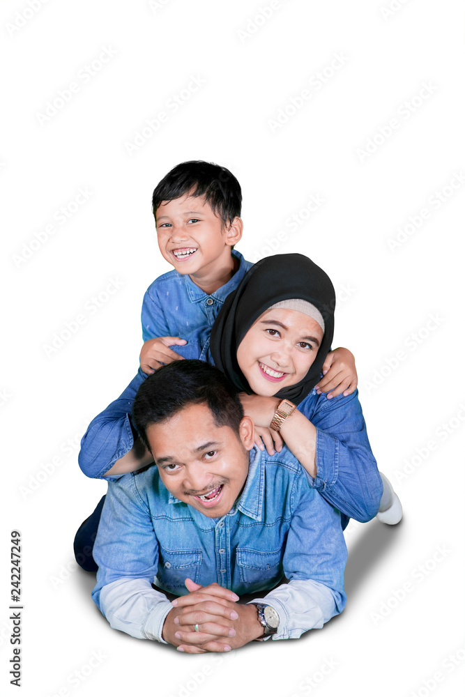 Young Muslim family lying on the floor Young Muslim family lying on the floor