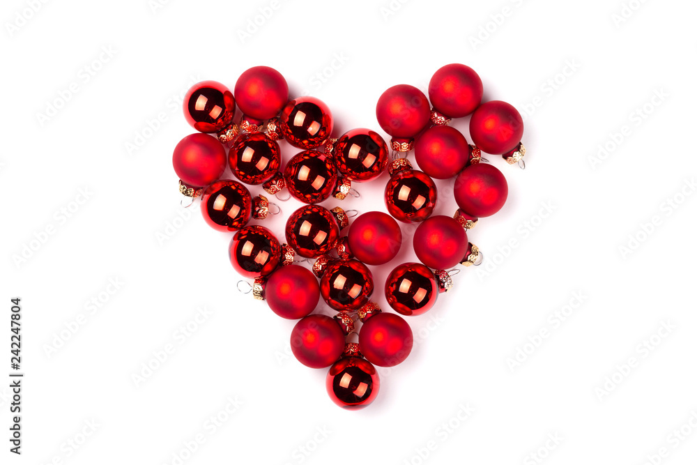 Shape of heart made of Christmas balls isolated on white. Top view. Shape of heart made of Christmas balls isolated on white. Top view.
