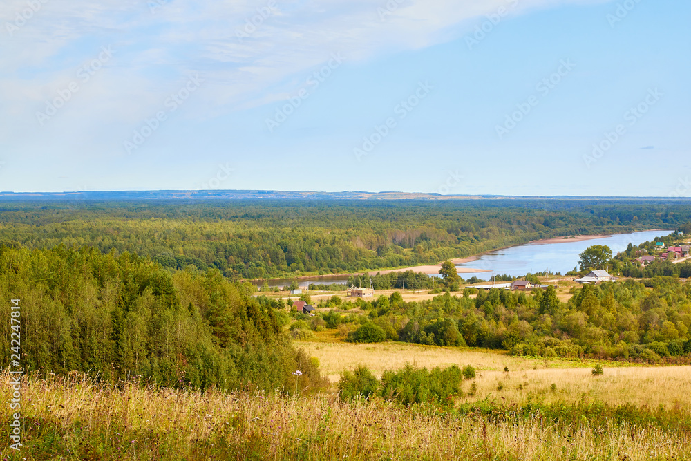 Beautiful view from the height of the landscape with fields, forests and river