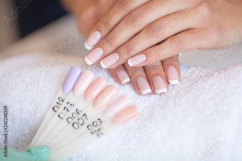 Manicure. Skillful master of manicure holding file in her hands while working in her beauty salon