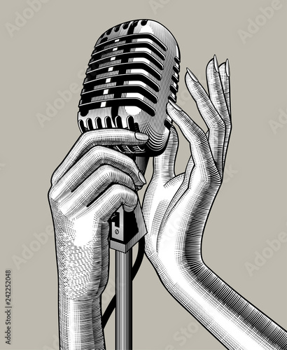 Female hands with a retro microphone