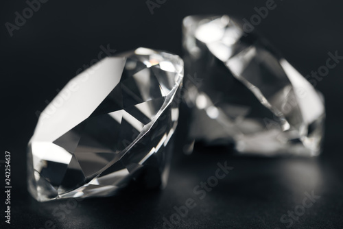 close up of two clear diamonds on black background