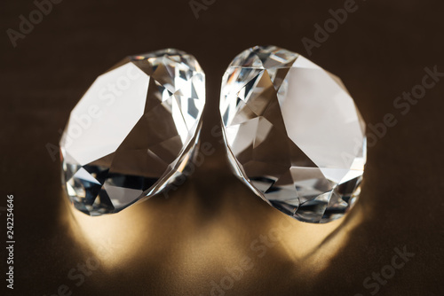 close up of clear diamonds on golden dark background