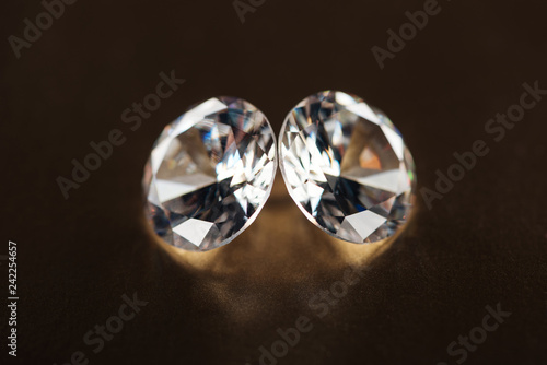 close up of big pure diamonds on golden dark background