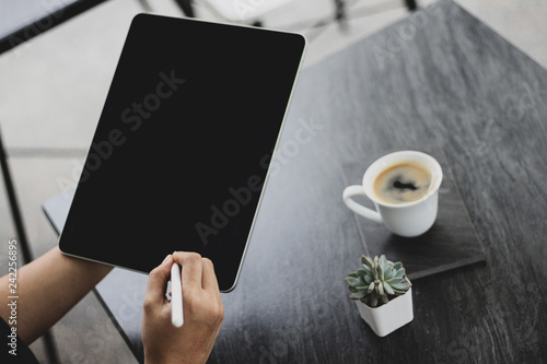 Mock up of a woman holding digital tablet device in hands with digital pencil. Tablet and digital pen connecting wifi. Copy space. - Image