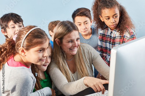 Lehrerin und Schüler Gruppe am Computer
