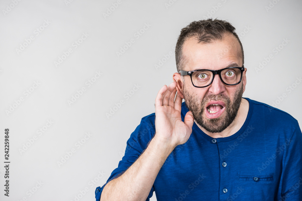 Man eavesdropping with hand close to ear Man eavesdropping with hand close to ear