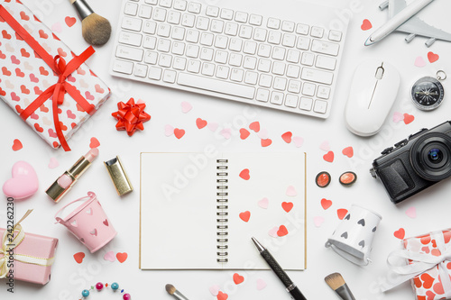 Valentine's Travel concept, blank space notebook, female cosmetics, gift box, wireless keyboard and mouse on white background.