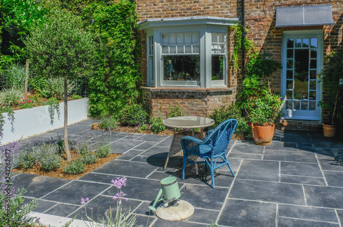 Wicker table and chair on an empty patio area.