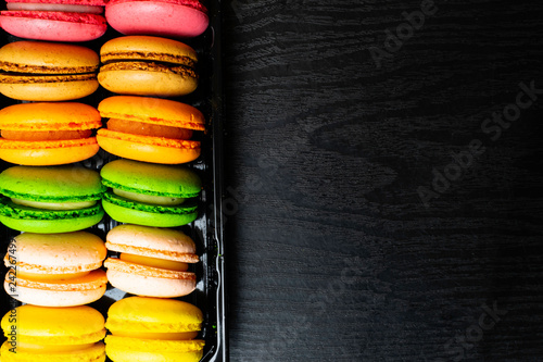 the many sweet colorful macaroons in box photo