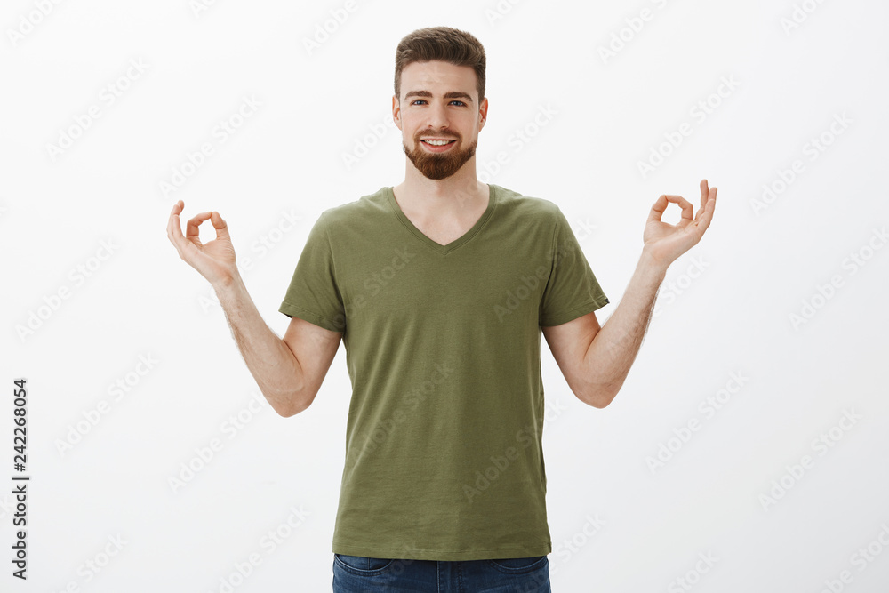 Guy feeling calm and relaxed, stress free thanks to new pills, smiling broadly and releaved holding hands in zen, lotus gesture smiling pleased meditating and practicing yoga over white background Guy feeling calm and relaxed, stress free thanks to new pills, smiling broadly and releaved holding hands in zen, lotus gesture smiling pleased meditating and practicing yoga over white background