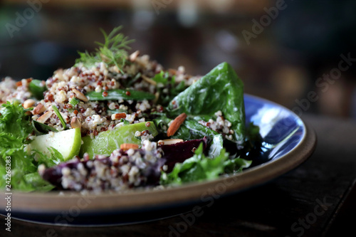 Quinoa salad with vegetable on wooden table