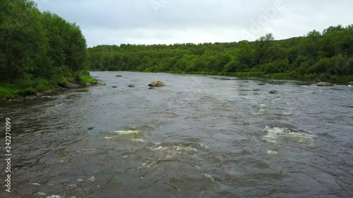 Stones and waves in the fast water of Pechenga river in northern part of Russia photo