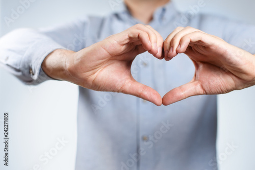 Male hands forming a heart shape