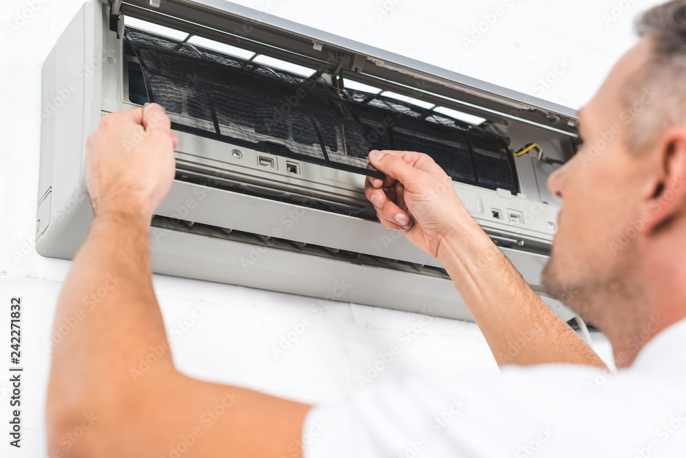 close up view of man fixing filter of air conditioner