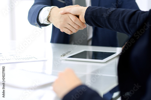 Group of business people or lawyers shaking hands finishing up a meeting , close-up. Success at negotiation and handshake concepts