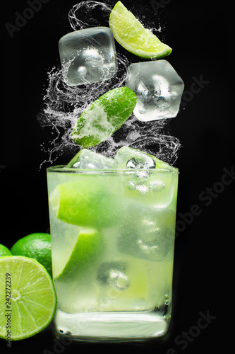 Brazilian caipirinha splash in black background